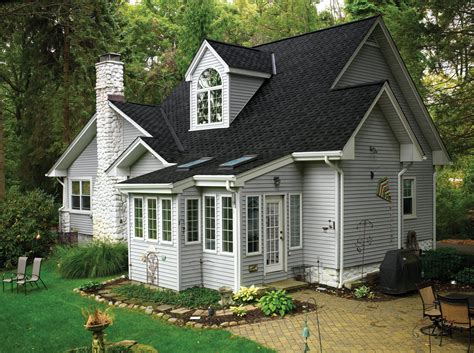 light grey house with black metal roof|grey houses with black shutters.